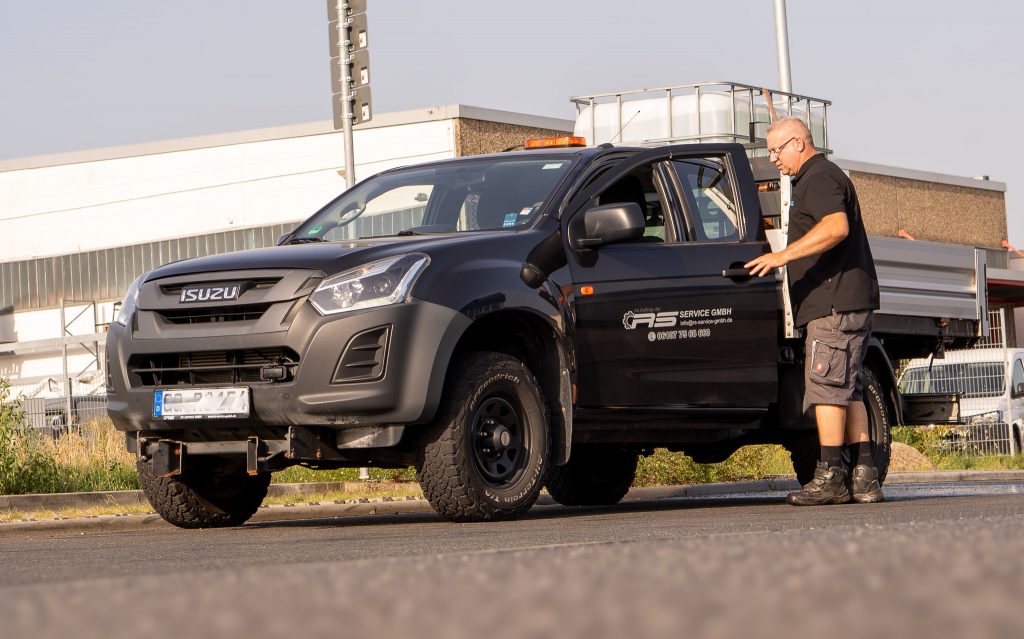 Mitarbeiter steigt in einen Pick-Up